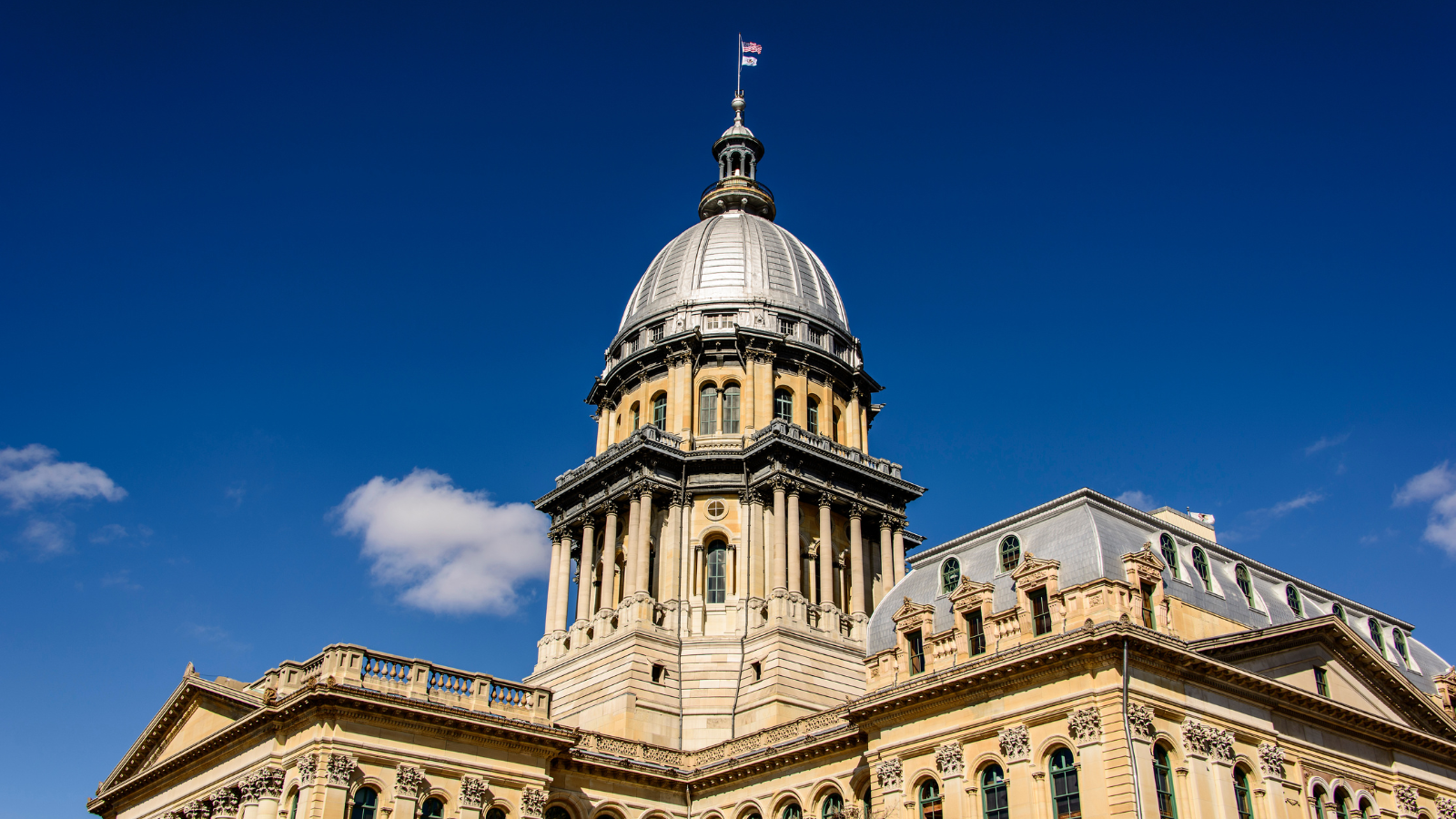 IL state capitol building with a blue sky background.